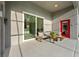 Covered patio area featuring a comfortable seating arrangement and modern design elements at 27338 Hollybrook Trl, Wesley Chapel, FL 33544