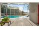 Inviting screened-in pool with a tranquil view of the surrounding greenery at 27338 Hollybrook Trl, Wesley Chapel, FL 33544