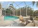 Relaxing screened pool area, complete with outdoor seating, perfect for entertaining at 27338 Hollybrook Trl, Wesley Chapel, FL 33544