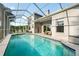 Large screened pool area with views of the house and landscaped backyard at 27338 Hollybrook Trl, Wesley Chapel, FL 33544