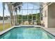 Inviting pool with screened enclosure, and outdoor lounge space, perfect for relaxation at 27338 Hollybrook Trl, Wesley Chapel, FL 33544