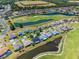 Beautiful aerial view of a well-maintained community with lush landscaping, a golf course, and several ponds at 29432 Coharie Loop, San Antonio, FL 33576