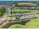 Beautiful aerial view of a well-maintained community with lush landscaping, a golf course, and several ponds at 29432 Coharie Loop, San Antonio, FL 33576