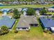 Aerial view of a home with a screened-in lanai, surrounded by a well-maintained lawn and manicured landscaping at 29432 Coharie Loop, San Antonio, FL 33576