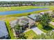 Scenic aerial view of a home with a golf course and water views at 29432 Coharie Loop, San Antonio, FL 33576
