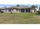Spacious backyard with a screened-in lanai, providing ample space for outdoor activities and relaxation at 29432 Coharie Loop, San Antonio, FL 33576