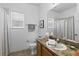 Bright bathroom features tile flooring, a large mirror, and a shower with a decorative shower curtain at 29432 Coharie Loop, San Antonio, FL 33576