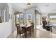 Bright dining area with tile flooring, sliding glass doors, and views of the outdoor space and living area at 29432 Coharie Loop, San Antonio, FL 33576