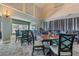 An inviting dining room featuring tables and chairs under elegant lighting with a view to the pool at 29432 Coharie Loop, San Antonio, FL 33576