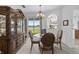 Charming dining room with classic details including a glass table and china cabinet, and views of the lake at 29432 Coharie Loop, San Antonio, FL 33576