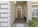 Inviting entryway with a brick floor, decorative lighting, and a stylish front door at 29432 Coharie Loop, San Antonio, FL 33576