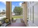 Inviting front porch with a cozy bench, offering a glimpse of the well-manicured lawn and neighborhood at 29432 Coharie Loop, San Antonio, FL 33576