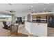 Open-concept kitchen features granite countertops and stainless steel appliances, seamlessly flowing into the living area at 29432 Coharie Loop, San Antonio, FL 33576