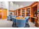 A cozy library with floor to ceiling bookshelves and comfortable seating for reading and relaxation at 29432 Coharie Loop, San Antonio, FL 33576