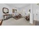Cozy living room with plush seating, a large window with shutters, and stylish decor at 29432 Coharie Loop, San Antonio, FL 33576