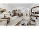 Elegant living room featuring classic furniture, a large mirror, and seamless transitions to dining spaces at 29432 Coharie Loop, San Antonio, FL 33576