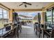 Covered outdoor seating with tables, chairs, and open views of the surrounding landscape and nearby pool at 29432 Coharie Loop, San Antonio, FL 33576
