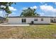 View of the home's backyard featuring a patio and sliding glass doors at 324 Country Club Dr, Oldsmar, FL 34677