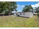 Backyard view showing the property's side and rear with a small patio at 324 Country Club Dr, Oldsmar, FL 34677