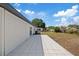 Large backyard features a concrete patio and lush lawn, perfect for outdoor activities at 324 Country Club Dr, Oldsmar, FL 34677