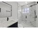 Modern bathroom with glass-enclosed shower, marble-style walls, and black fixtures at 324 Country Club Dr, Oldsmar, FL 34677
