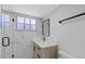 Bathroom featuring new vanity, shower with glass doors, modern fixtures, and marble-style tiling at 324 Country Club Dr, Oldsmar, FL 34677