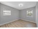 Cozy bedroom featuring wood floors and windows for natural light at 324 Country Club Dr, Oldsmar, FL 34677