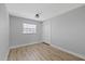 Simple bedroom with wood flooring, a double door closet, and a window for natural light at 324 Country Club Dr, Oldsmar, FL 34677