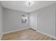 Well-lit bedroom with hardwood floors, a window, and a closet at 324 Country Club Dr, Oldsmar, FL 34677