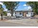 Landscaped single-story home with a picket fence, renovated exterior, and well-maintained front yard at 324 Country Club Dr, Oldsmar, FL 34677