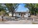 Charming single-story home with a white picket fence and mature trees in a sunny outdoor setting at 324 Country Club Dr, Oldsmar, FL 34677