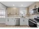 Bright kitchen with stainless steel dishwasher, appliances and tile backsplash at 324 Country Club Dr, Oldsmar, FL 34677