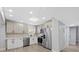 Bright kitchen with stainless steel appliances, ample cabinet space, and modern light fixtures at 324 Country Club Dr, Oldsmar, FL 34677