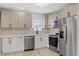 Modern kitchen with stainless steel appliances, light wood cabinets, and a decorative backsplash at 324 Country Club Dr, Oldsmar, FL 34677