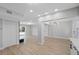Inviting living area with light wood floors, recessed lighting, and access to backyard at 324 Country Club Dr, Oldsmar, FL 34677