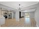 Bright living area with modern light fixtures, light wood floors, and a stunning marble fireplace at 324 Country Club Dr, Oldsmar, FL 34677