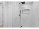 Walk-in shower with glass doors and black fixtures, complemented by marble-look tiling at 324 Country Club Dr, Oldsmar, FL 34677