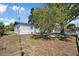 Angle shot of the house showing a side yard and exterior details at 324 Country Club Dr, Oldsmar, FL 34677