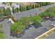 An aerial view showcases the yellow apartment building, parking lot, and surrounding green trees at 3437 Dragon View Ct, Valrico, FL 33594