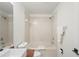 Bright bathroom featuring a shower-tub combo with tiled walls at 3437 Dragon View Ct, Valrico, FL 33594