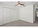 Bedroom featuring plush carpeting, ceiling fan, and large closet at 3437 Dragon View Ct, Valrico, FL 33594