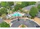 Aerial view of the community pool with lounge chairs and palm trees at 3437 Dragon View Ct, Valrico, FL 33594