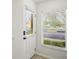 Bright entryway featuring a storm door with built-in blinds and a large window, creating a welcoming ambiance at 3437 Dragon View Ct, Valrico, FL 33594