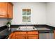 Galley kitchen featuring granite countertops, stainless steel appliances, wood cabinets, and ample natural light at 3437 Dragon View Ct, Valrico, FL 33594
