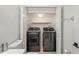 A picture of a laundry room with modern washer and dryer, and a toilet at 3437 Dragon View Ct, Valrico, FL 33594
