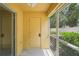 View of the exterior door, sliding glass door, and backyard from the screened porch at 3437 Dragon View Ct, Valrico, FL 33594