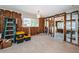 Dining room undergoing renovation with exposed framing, original terrazzo flooring and an adjacent room at 3962 Poinsettia Dr, St Pete Beach, FL 33706