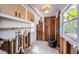 Bright laundry room with white cabinets and a window at 3962 Poinsettia Dr, St Pete Beach, FL 33706