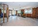 Spacious living room featuring terrazzo floors, bright windows and a ceiling fan at 3962 Poinsettia Dr, St Pete Beach, FL 33706