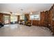 Renovated living room with exposed framing, original terrazzo flooring and an open-concept design at 3962 Poinsettia Dr, St Pete Beach, FL 33706